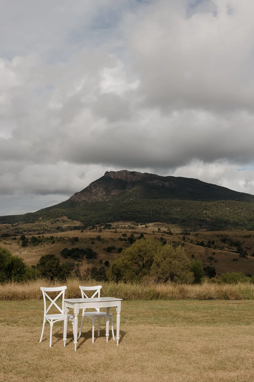 Empty white bench seating overlooking the Scenic Rim mountains