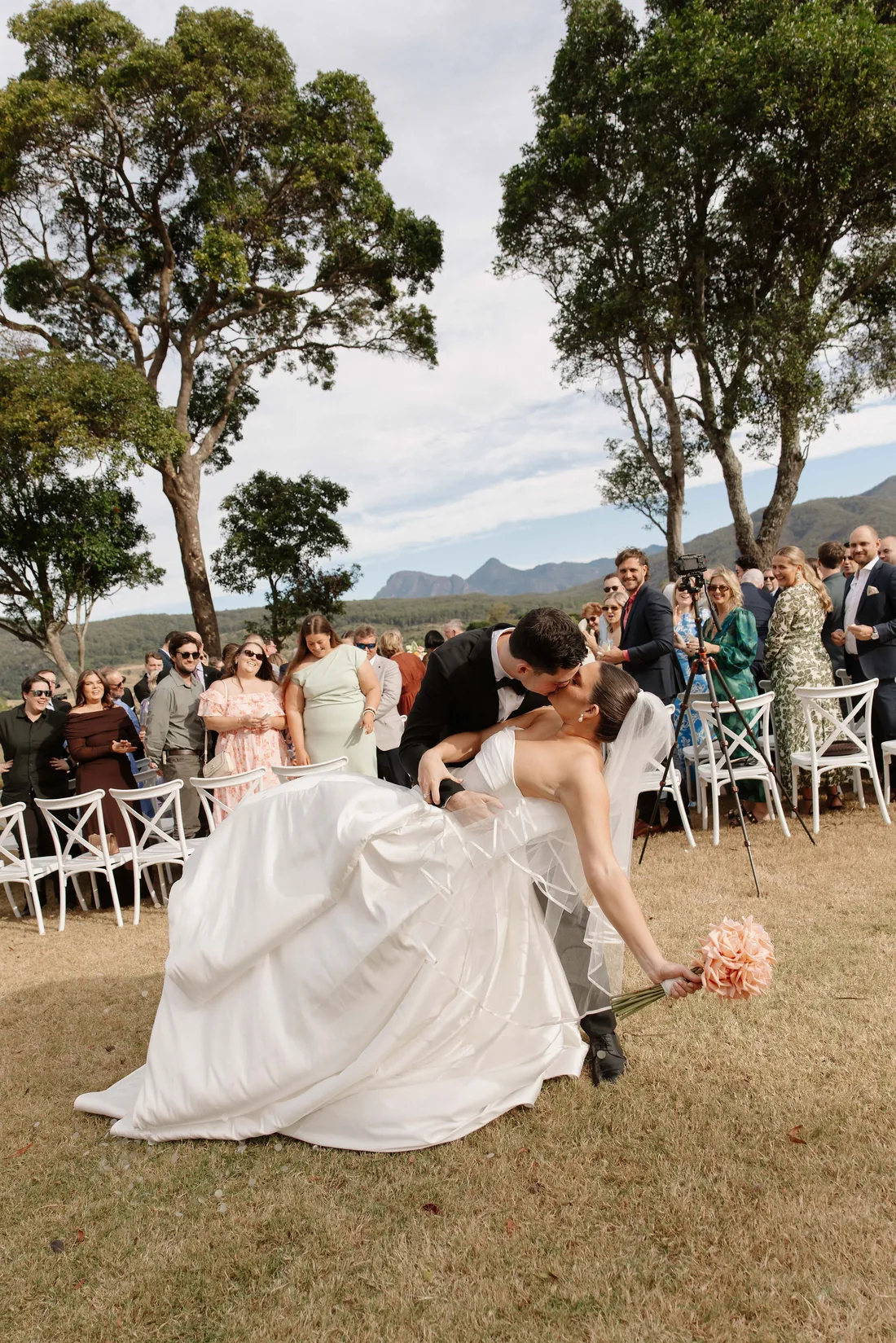 Connor dipping Laura for a kiss after the ceremony as guests celebrate