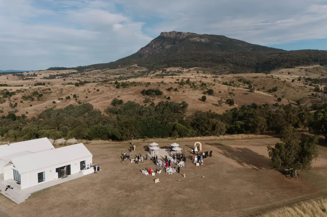 Aerial view of the reception venue and ceremony setup nestled beneath the mountains