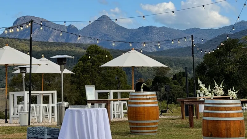 The cocktail area set up with barrels and festoon lights, the ranges behind